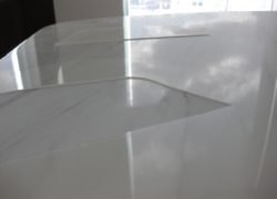 The Acrylic Coating on the Marble Dining Table has come apart and reveals scratches and damage